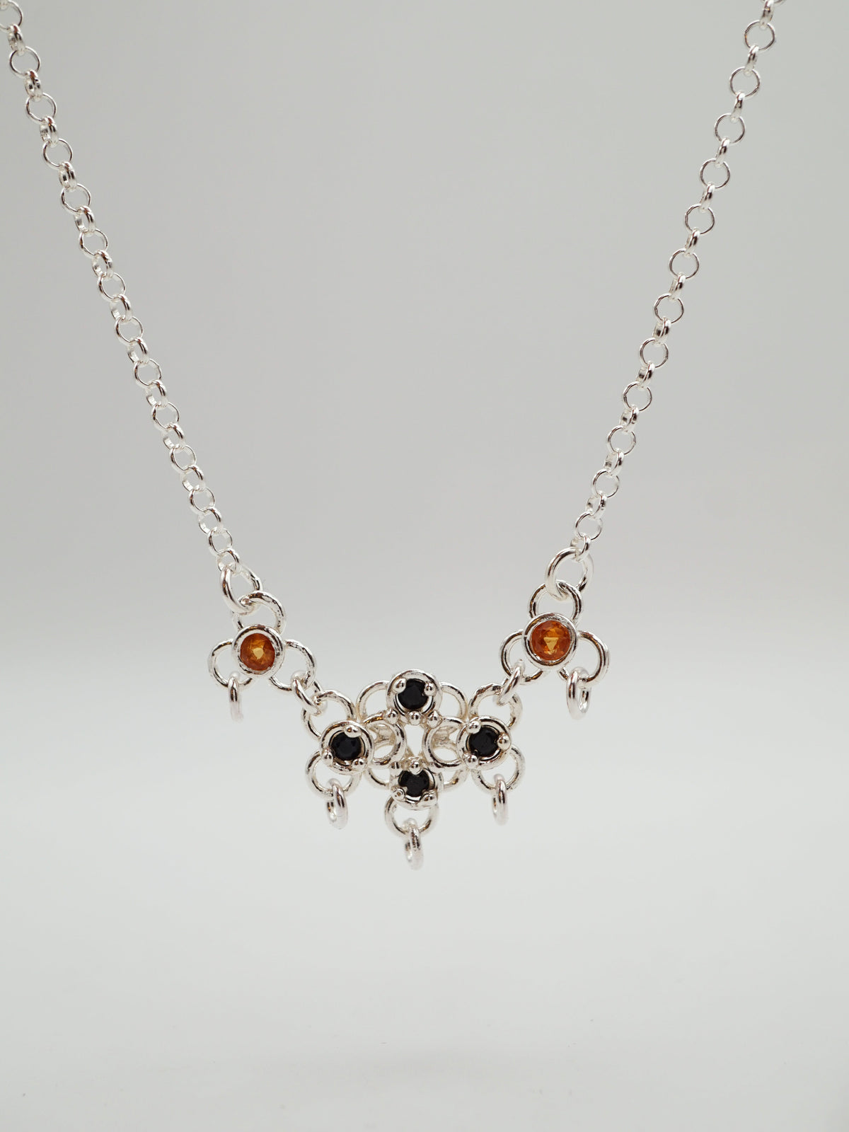 sterling silver TRAME necklace with blue and orange sapphires