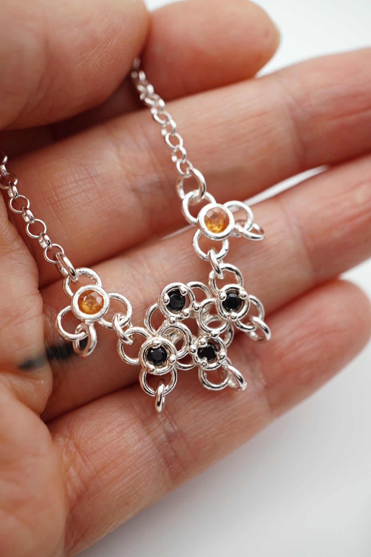 sterling silver TRAME necklace with blue and orange sapphires
